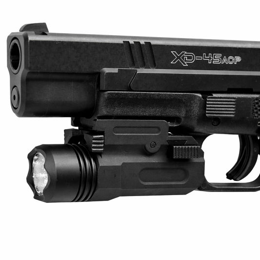 Black handgun with flashlight attachment on a white background