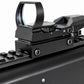 A close-up of a black tactical red dot sight mounted on a black rifle rail, shown against a plain white background.