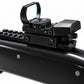 A close-up studio shot of a black tactical rifle scope mounted on a black firearm receiver, shown against a plain white background.