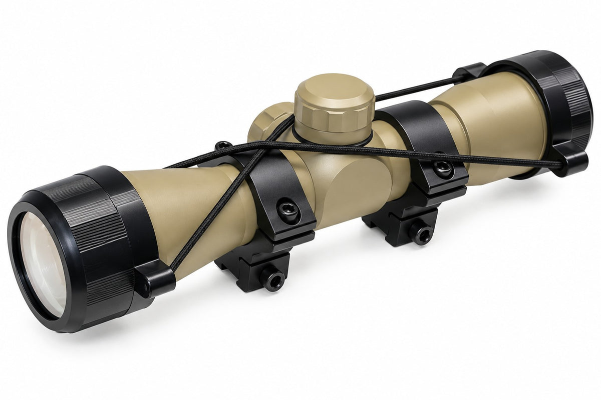 TRINITY 4x32 Mil-Dot scope in tan with blue multi-coated objective lens, aluminum housing, adjustment turrets, and black dovetail mounting rings on a white background.