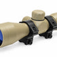 TRINITY 4x32 Mil-Dot scope in tan with blue multi-coated objective lens, aluminum housing, adjustment turrets, and black dovetail mounting rings on a white background.